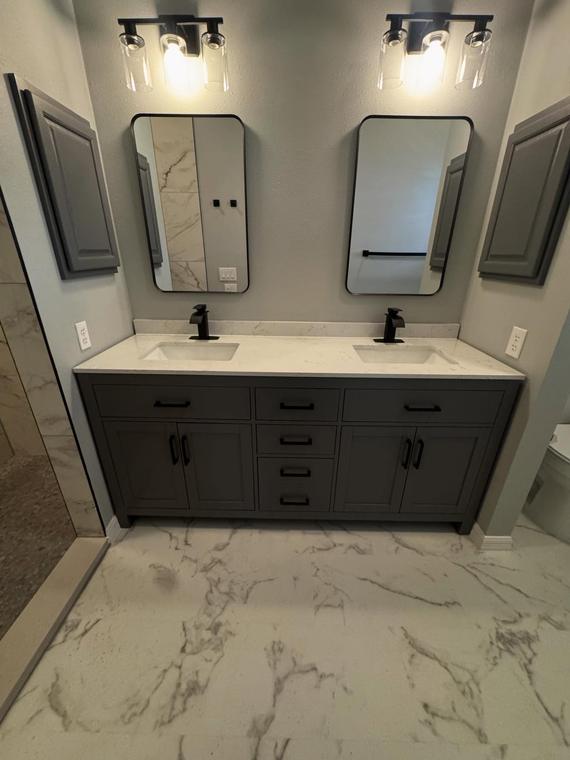 Double vanity with matte black fixtures and marble-look porcelain floor