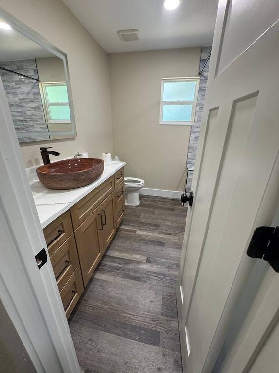 Vanity with vessel sink and full-height mirror