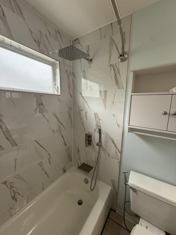 Rain head and handheld on the finished porcelain wall