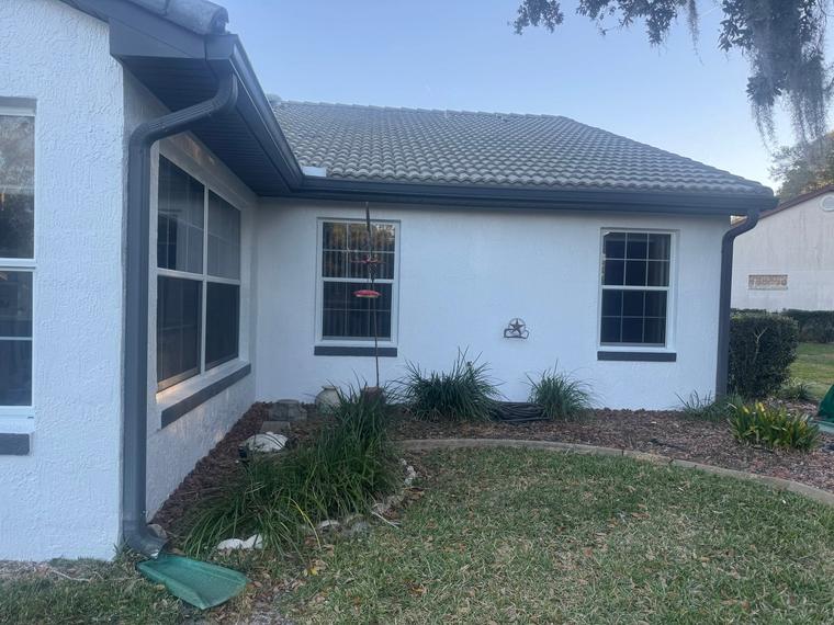 Exterior painting with clean cut lines at the roofline