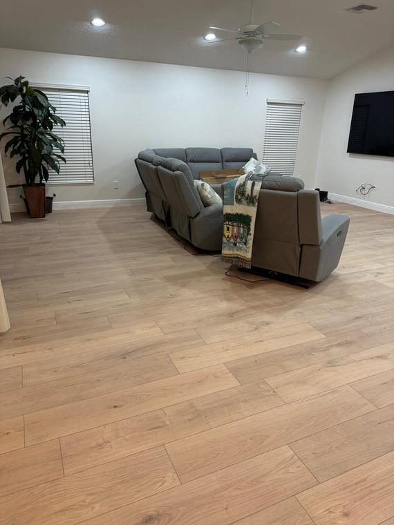 Living room floor replaced with wide-plank luxury vinyl