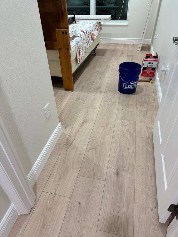 Wide-plank LVP running through the main hallway