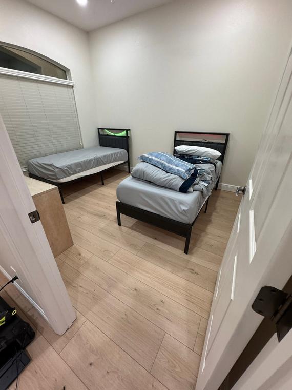Bedroom carpet replaced with wide-plank flooring