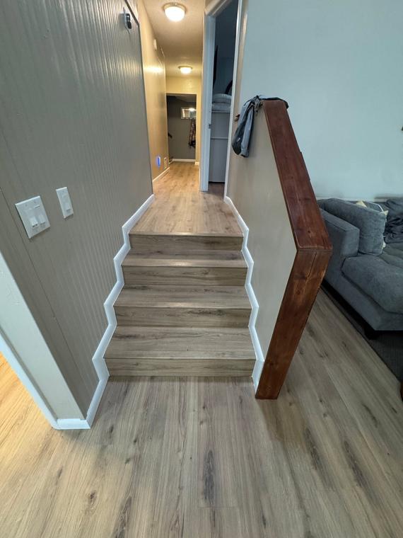 Stair landing and hallway in matching plank flooring