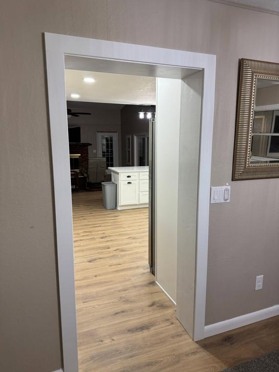 Open hallway and living space in continuous plank flooring