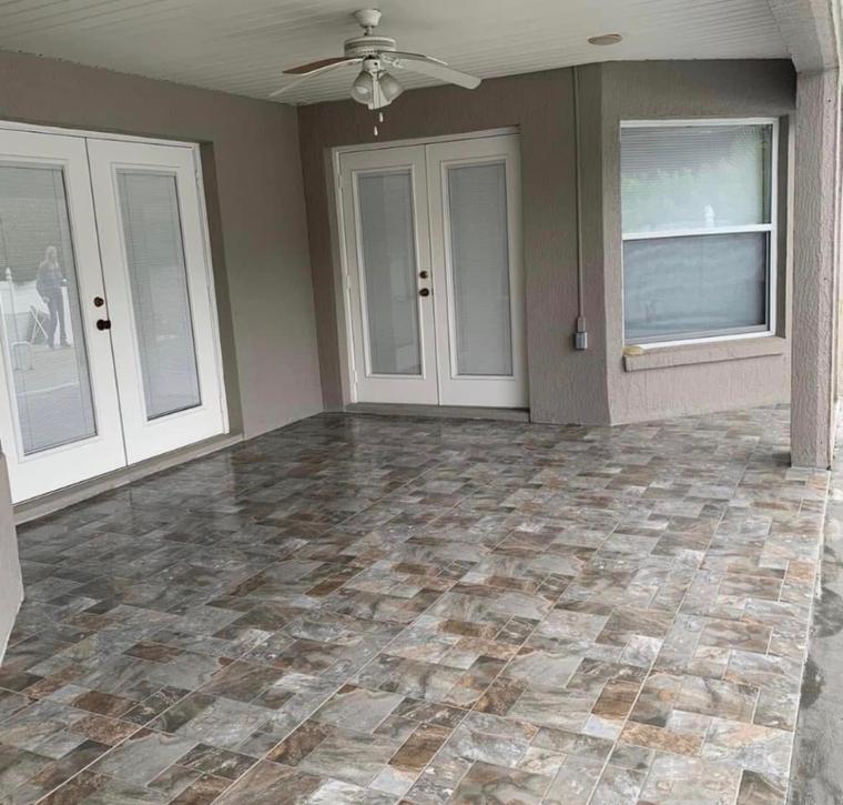 Covered patio finished in large-format stone-look tile