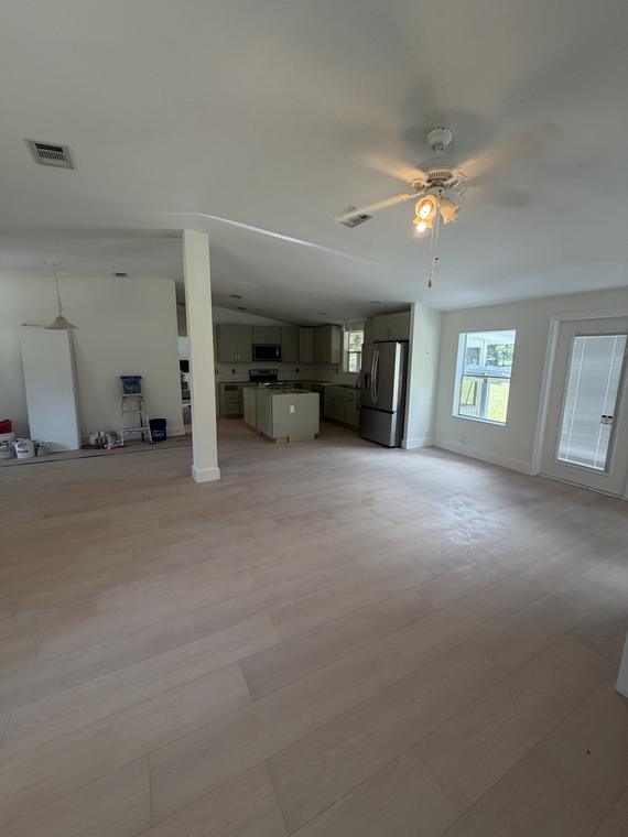Open living space and kitchen, wall to wall in wide-plank flooring