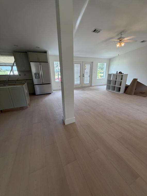 Kitchen and living room sharing one continuous floor