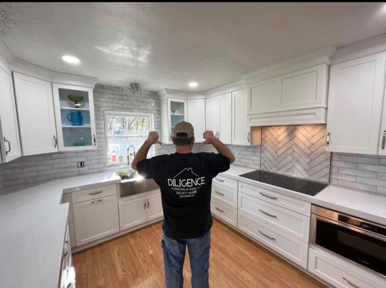 Kitchen remodel with shaker cabinetry, herringbone backsplash and farmhouse sink