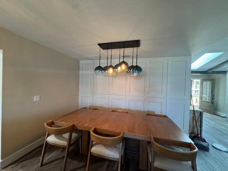 Dining room wall paneling and statement lighting