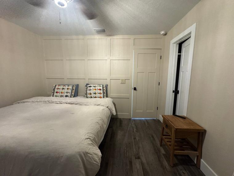 Guest bedroom with panel moulding and new flooring