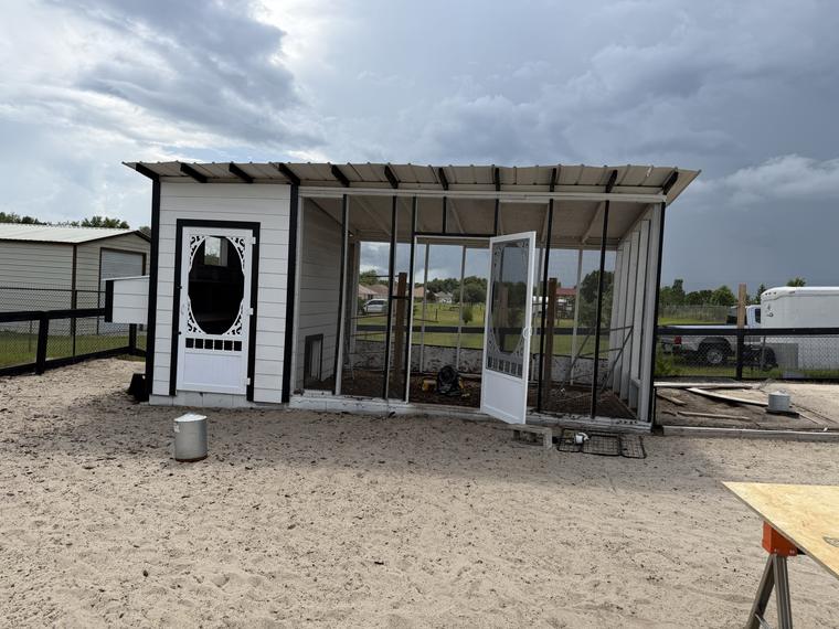 Custom-built chicken coop with a covered, screened run